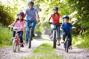 family cycling along a trail
